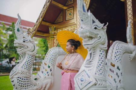 South Asian model in Thai costume Chiang Mai Thailand Buddhist temple