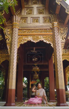 Entry facade and wooden Architectural ornamentations of an Old Buddhist temple in Northern Thailand