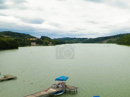 Photo for Pedalo and boats on water of Ostrzyckie Lake in Wiezyca, Kashubian region, Poland. Leisure and tourism concept. - Royalty Free Image