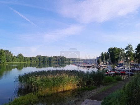 Photo for View of Lake Wdzydze and the marina in the distance. Sailing on Lake Wdzydze, one of the largest lakes in Poland. Nature and exploration concept. - Royalty Free Image