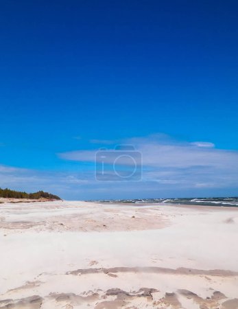 Sandy beach in Stilo, Poland. Baltic Sea coast. copy space on blue sky.