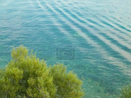 Beautiful water of Lake Ochrid as nature background. Ochrid is the oldest lake in Europe. Mediterranean nature, copy space.