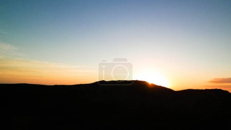 Beautiful sunset over extinct volcano Montana Roja. Montana Roja is a volcano on Lanzarotte, Canary Islands. Copy space on colorful sky.