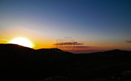 Beautiful sunset over extinct volcano Montana Roja. Montana Roja is a volcano on Lanzarotte, Canary Islands. Copy space on colorful sky.
