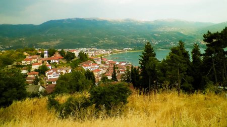 Coast of Lake Ochrid seen from Ochrid City. Ochrid is the oldest lake in Europe, known of its, clean, transparent water. Ohrid and Lake Ohrid are UNESCO natural and cultural heritage sites. Typical Macedonian architecture. Travel and Architecture con