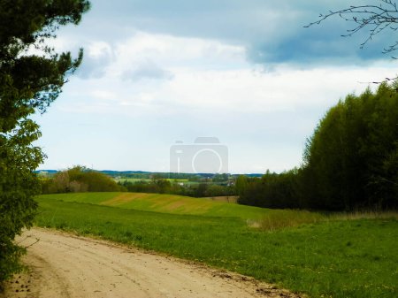 Rural road through Kashubian fields. Travel and nature concept. Northern Poland.