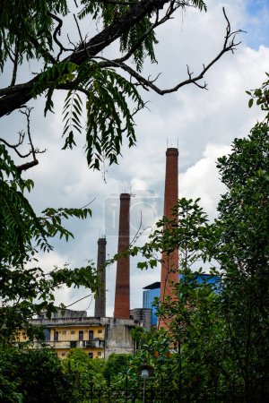 Photo for Close-up of chimneys in industrial area on the outskirts of the city - Royalty Free Image
