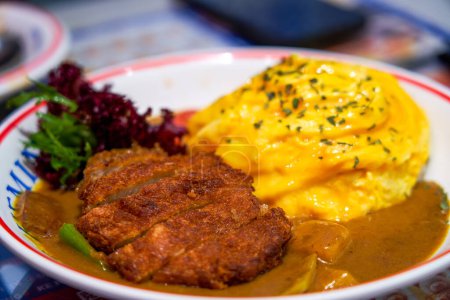 Crispy and delicious curry fried pork cutlet and omelette rice in Hong Kong style tea restaurant