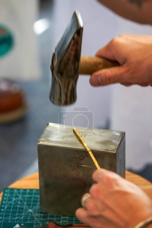 Un artesano tradicional crea joyas de metal