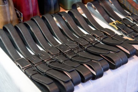 Close-up of genuine leather belts for sale in store