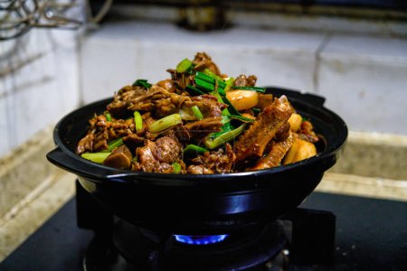 A Chinese chef is cooking braised duck