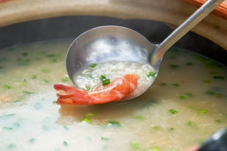 A pot of delicious seafood and shrimp porridge for camping on the beach