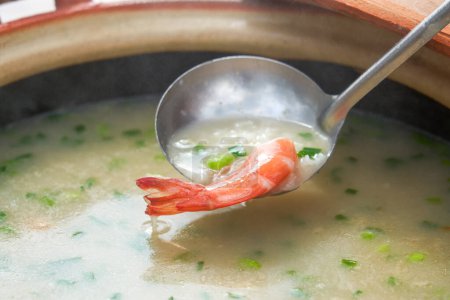 A pot of delicious seafood and shrimp porridge for camping on the beach