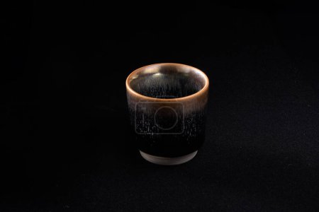 Beautiful Chinese Fujian Jianzhan tea cup on black background