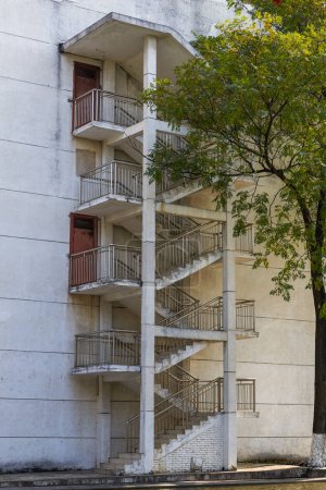 Foto de Primer plano de escaleras alternativas colgadas en la pared exterior de un edificio de la ciudad - Imagen libre de derechos