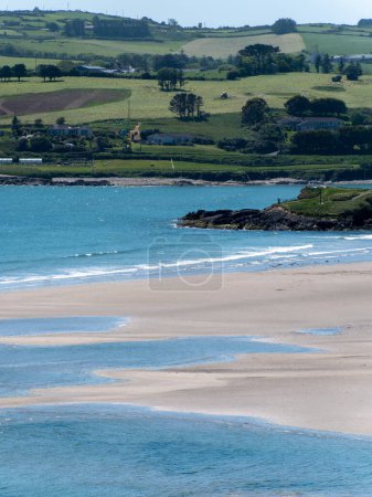 Photo for Inchydoney beach at low tide on a sunny spring day. The famous Irish beach on the south coast of the country. Seaside landscape. - Royalty Free Image