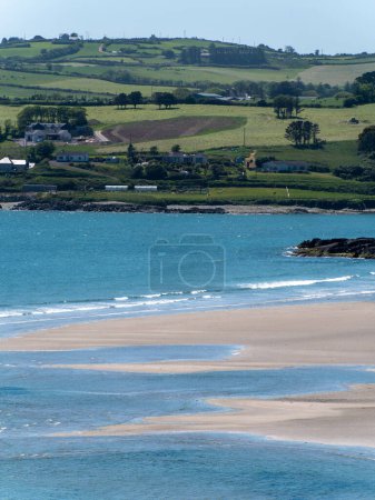 Photo for Inchydoney beach at low tide on a sunny day. The famous Irish beach on the south coast of the country. Seaside landscape. - Royalty Free Image