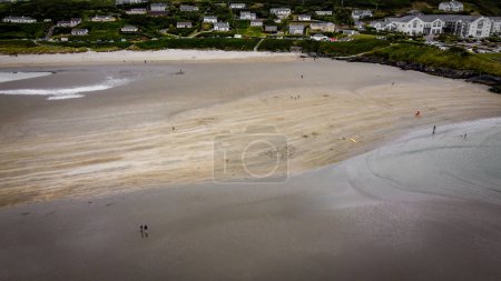Photo for The famous Irish beach of Inchydoney at low tide, top view. Houses on the seashore. Huge sandy beach. - Royalty Free Image