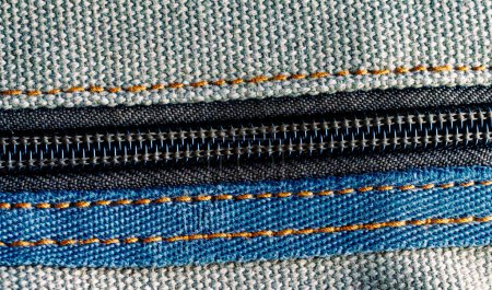 A zoomed-in view of a zipper embedded in textured cloth.