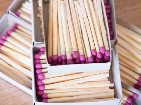 Photo for Ready-to-Strike Matches. Pink-tipped matches in boxes, symbolizing readiness. Uses for Fire safety instructions, survival guides. - Royalty Free Image