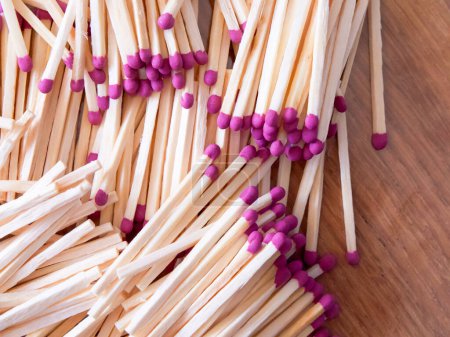 Photo for Striking Matches. Matches with purple tips, scattered arrangement. Uses for Product packaging, creative projects. - Royalty Free Image
