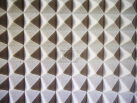 Sound Insulation Foam. Close-up of grey, pyramid-shaped acoustic foam.