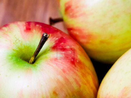 Colorful Apple Composition. Apples with varying shades, set against wood, suitable for dietary content.
