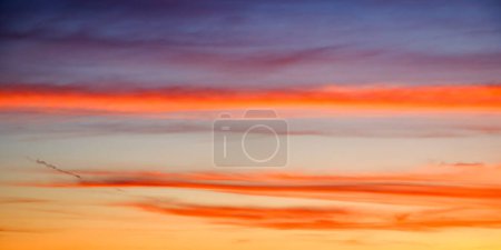 A serene sunset painting the sky with hues of orange, blue, and purple, evoking a sense of calm. Ideal for relaxation content.