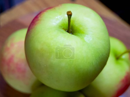 Healthy Snack Option. Vibrant apples on wood, symbolizing health and nutrition.