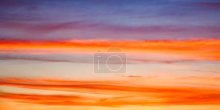 The sky ablaze with warm colors transitioning into cool tones, capturing natures artistry. Perfect for inspirational themes