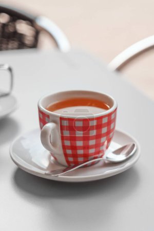 Photo for Black tea cup in a european city cafe close up. Urban style - Royalty Free Image