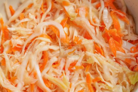 Fermented sauerkraut with chopped white cabbage and carrots. Macro shot
