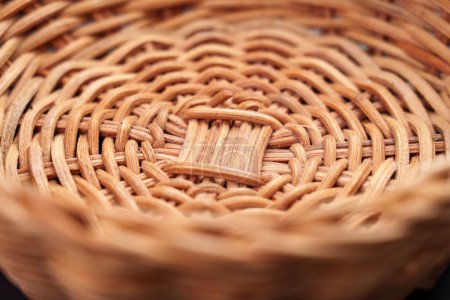 Textured pattern of empty handcraft rattan wicker bowl close up