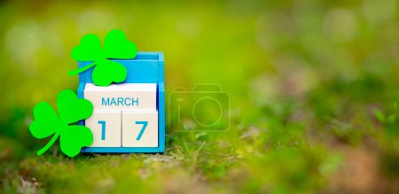 Photo for Save the date white block calendar for St Patricks Day, March 17 on green background. - Royalty Free Image