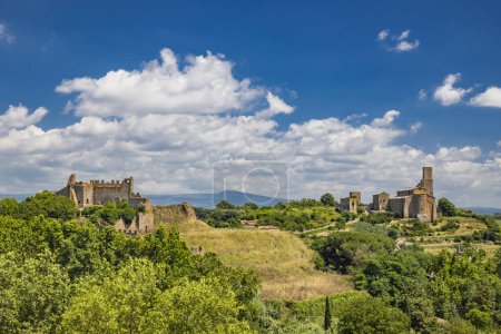 Photo for A view of the hills around the medieval village of Tuscania (city of the Etruscans), in the province of Viterbo, Lazio. The remains of the Rivellino Castle and the Romanesque church of San Pietro. - Royalty Free Image