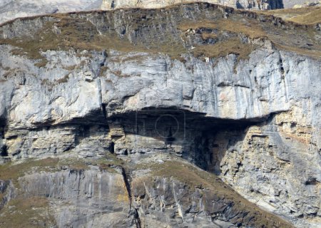 Photo for The Cave Adlerhorst or cave eagle's nest (Hoehle Adlerhorst / Hohle Adlerhorst) under the alpine peak Piz Fluaz (2814 m) in the Glarus Alps mountain massif, Pigniu-Panix - Canton of Grisons, Switzerland (Kanton Graubuenden, Schweiz) - Royalty Free Image