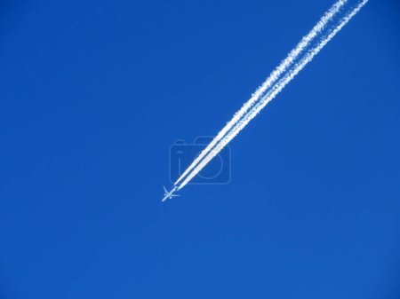 Photo for Unusual plane tracks in the blue autumn Swiss sky or conspiracy theory - chemtrails in our heaven (UNESCO World Heritage Tectonic Arena Sardona), Vaettis - Switzerland (Schweiz) - Royalty Free Image
