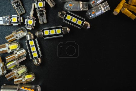 Photo for Different headlight lamp on dark, black background. Modern diode, classic halogen and other lamp. Copy space. The concept of production and sale of electric car spare parts and accessories - Royalty Free Image