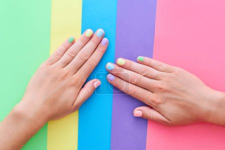 Photo for Female hands with bright summer color nails on a colorful background - Royalty Free Image