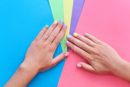 Photo for Female hands with bright color manicure on a colorful background - Royalty Free Image