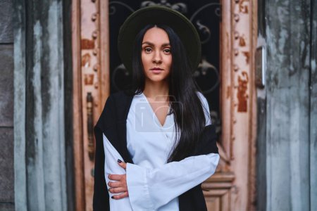 Photo for Portrait of stylish attractive serious mystic elegant woman standing at an old vintage building - Royalty Free Image