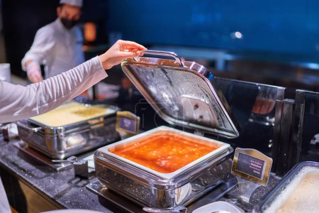 Foto de Catering buffet food with heated trays in hotel all inclusive service - Imagen libre de derechos
