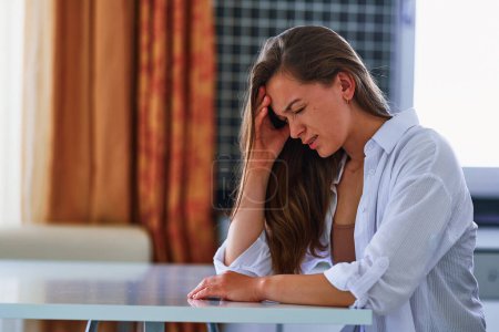 Photo for Unhealthy painful unhappy unwell young woman suffering from headache at home. Health problems - Royalty Free Image