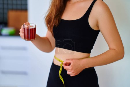 Photo for Fitness sportive healthy woman drinking herbal tea for weight loss and slimness body - Royalty Free Image