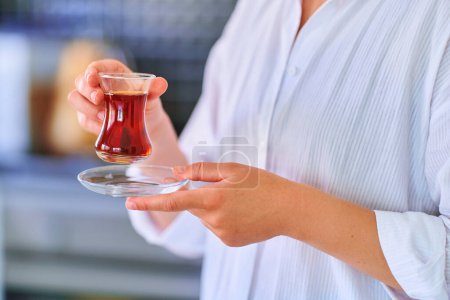 Photo for Female drinking traditional turkish tea - Royalty Free Image
