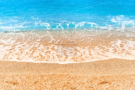 Téléchargez les photos : Fond d'écran bleu turquoise clair mer mousseuse et plage de sable par une journée d'été ensoleillée - en image libre de droit