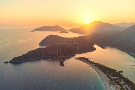 Photo for Beautiful landscape of mysterious scenic idyllic mountains in the sea lagoon in haze at sunset. Soft focus wallpaper - Royalty Free Image