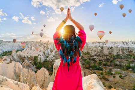 Photo for Boho girl traveler vacations beautiful destination in Goreme, Turkey. Fabulous Kapadokya with flying air balloons at sunrise, Anatolia - Royalty Free Image