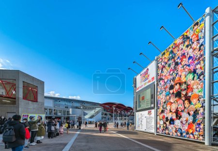 Photo for Chiba, japan - dec 18 2022: Japanese people taking photos of the advertising panel featuring all the characters published in the Weekly Jump magazine at the entrance of the convention Jump Festa '23. - Royalty Free Image