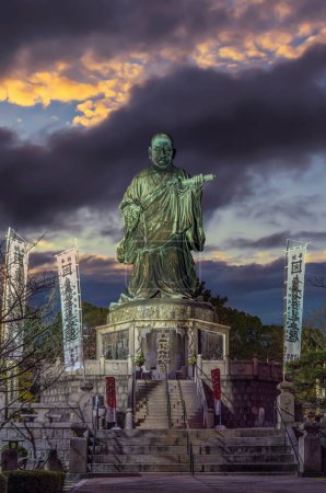 Photo for Fukuoka, japan - dec 07 2022: Third tallest bronze statue depicting  Japanese buddhist priest Nichiren created in 1904 with title of his treatise "Establishing Right Doctrine and Peace of the Nation". - Royalty Free Image